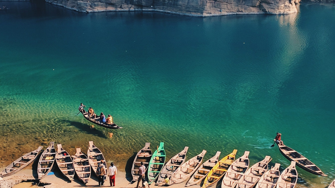 Crystal-clear waters of Dawki River with a boat floating in Meghalaya
