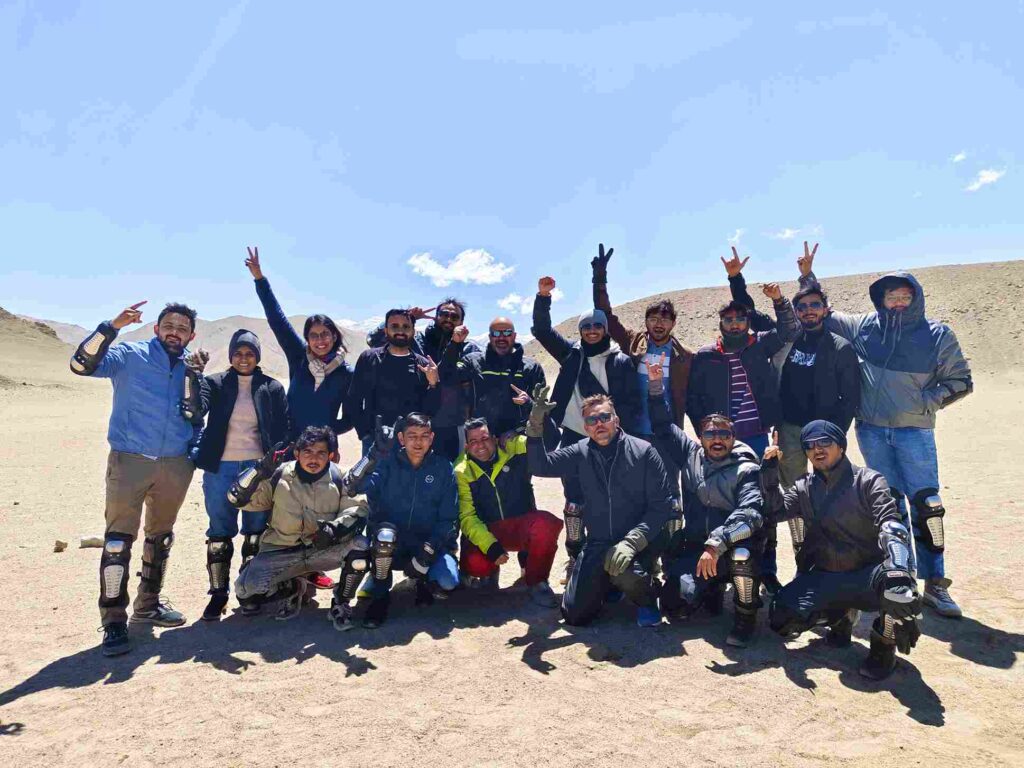 Group of bikers at Nubra Valley sand dunes during June bike trip in Ladakh