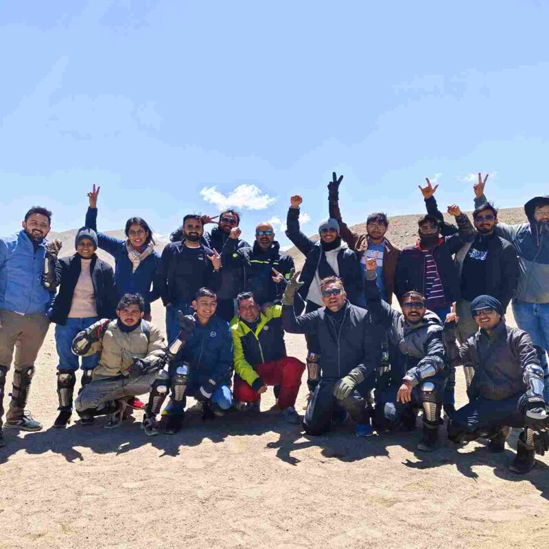 Biker riding towards Leh on a scenic Himalayan road during Delhi to Leh bike trip