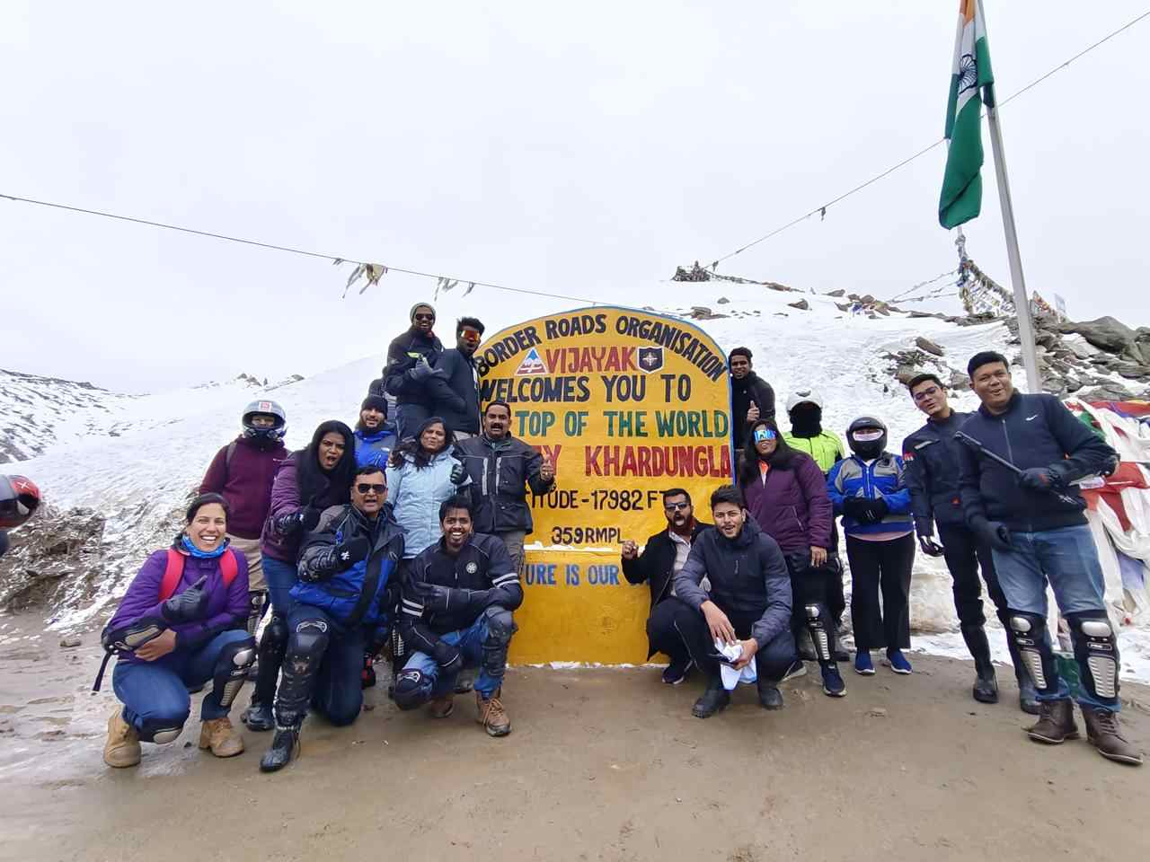 Bikers celebrating at Khardung La Pass, one of the highest motorable roads in the world