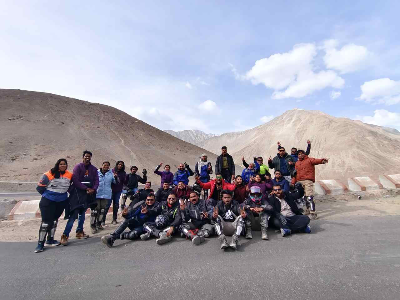 Bikers standing at Magnetic Hill in Ladakh on a road that defies gravity