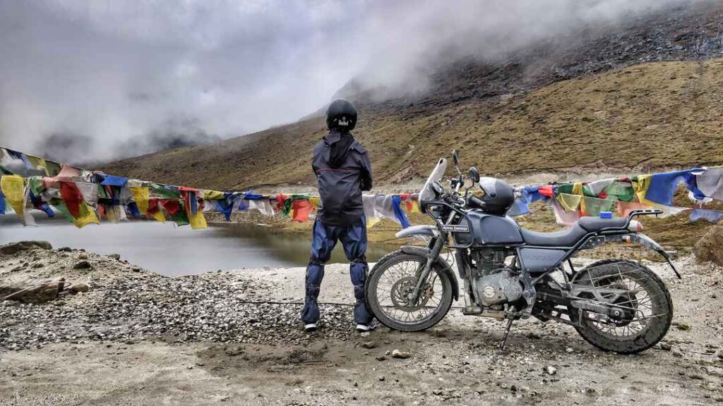 Biker crossing snow-covered Sela Pass on the way to Tawang, Arunachal Pradesh
