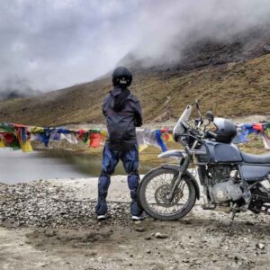 Biker crossing snow-covered Sela Pass on the way to Tawang, Arunachal Pradesh